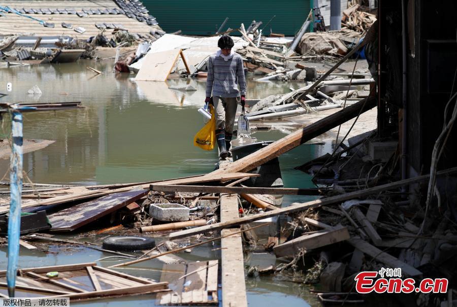 A local resident walks in a flooded area in Mabi town in Kurashiki, Okayama Prefecture, Japan, July 10, 2018. The death toll from widespread flooding and landslides rose to 126, according to Japanese authorities.  (Photo/Agencies)