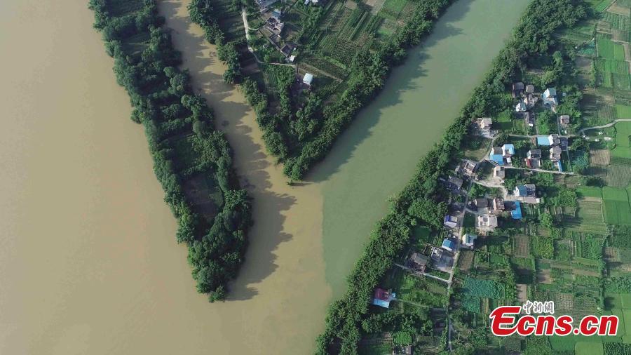 An aerial view of muddy water mixing with clean after strong rainfall in Rong’an County, South China’s Guangxi Zhuang Autonomous Region, July 10, 2018. (Photo: China News Service/Tan Kaixing)