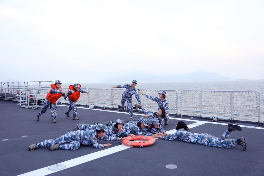Students from Dalian Naval Academy take a graduation photo on the deck of a training vessel during their graduation practice in June 2018. (Photo provided to chinadaily.com.cn)