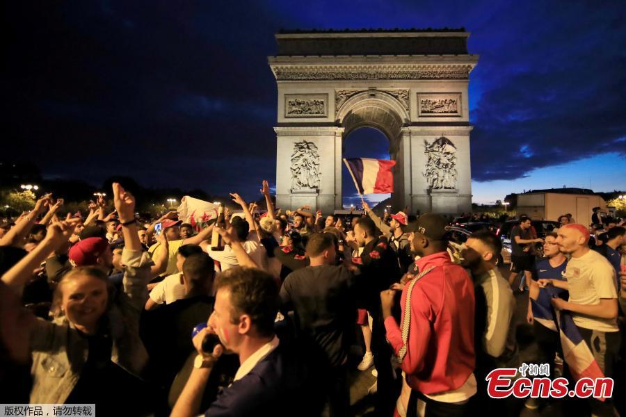France fans react on the Champs-Elysees in Paris, France, July 10, after defeating Belgium 1-0 in their World Cup semi-final match in St Petersburg. It means the 1998 World Cup winners will play either England or Croatia in the final on Sunday. (Photo/Agencies)