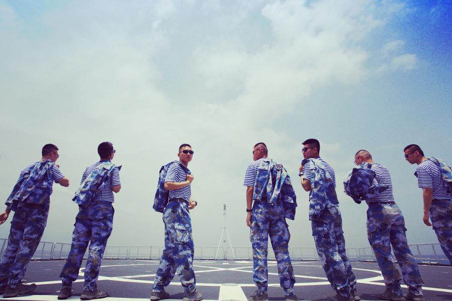 Students from Dalian Naval Academy take a graduation photo on the deck of a training vessel during their graduation practice in June 2018. (Photo provided to chinadaily.com.cn)