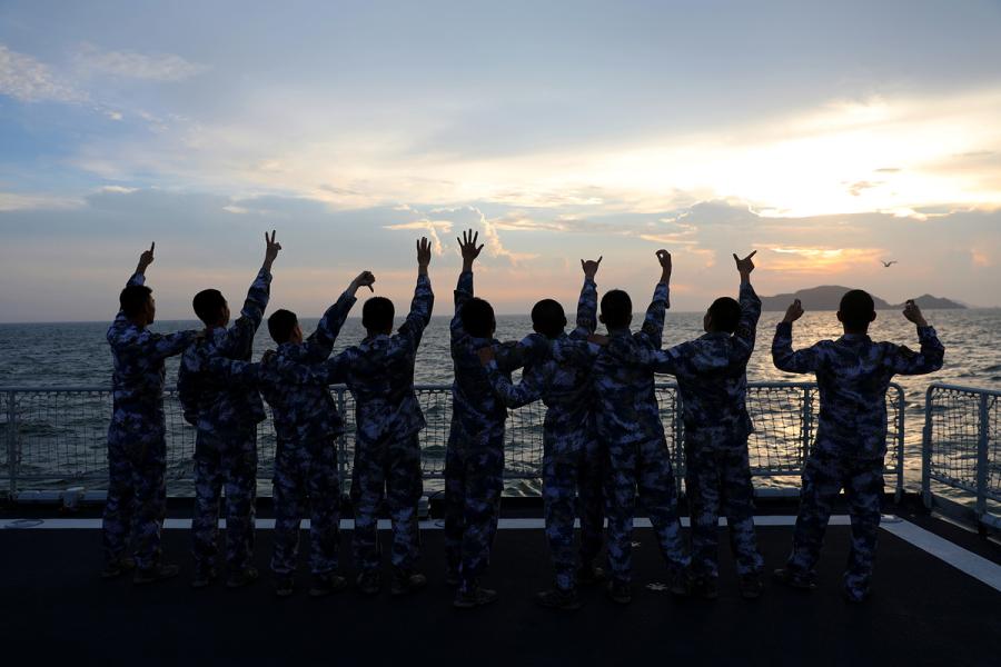 Students from Dalian Naval Academy take a graduation photo on the deck of a training vessel during their graduation practice in June 2018. (Photo provided to chinadaily.com.cn)