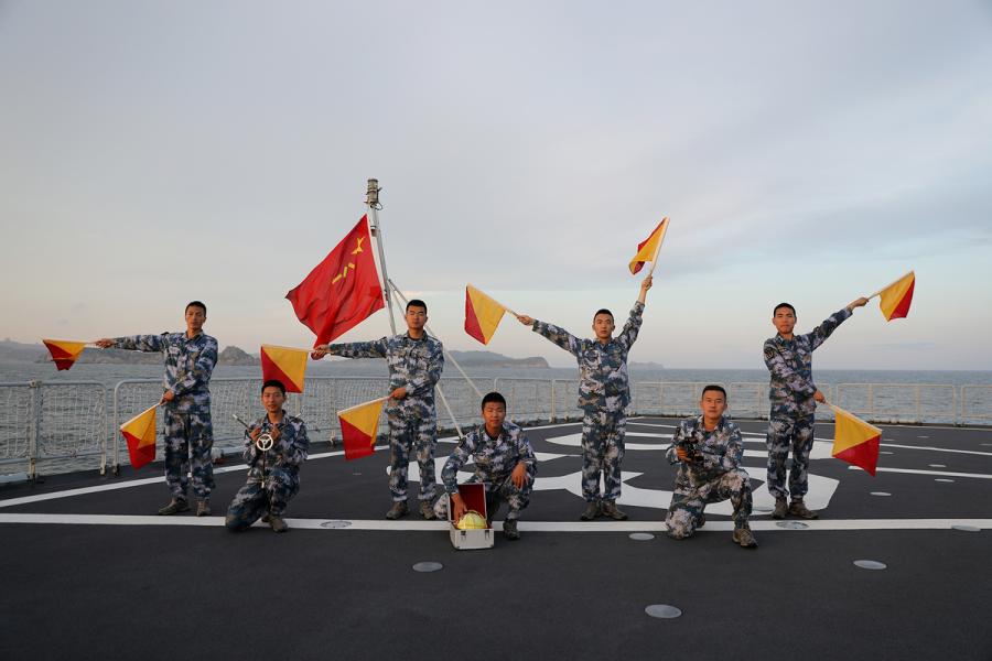 Students from Dalian Naval Academy take a graduation photo on the deck of a training vessel during their graduation practice in June 2018. (Photo provided to chinadaily.com.cn)