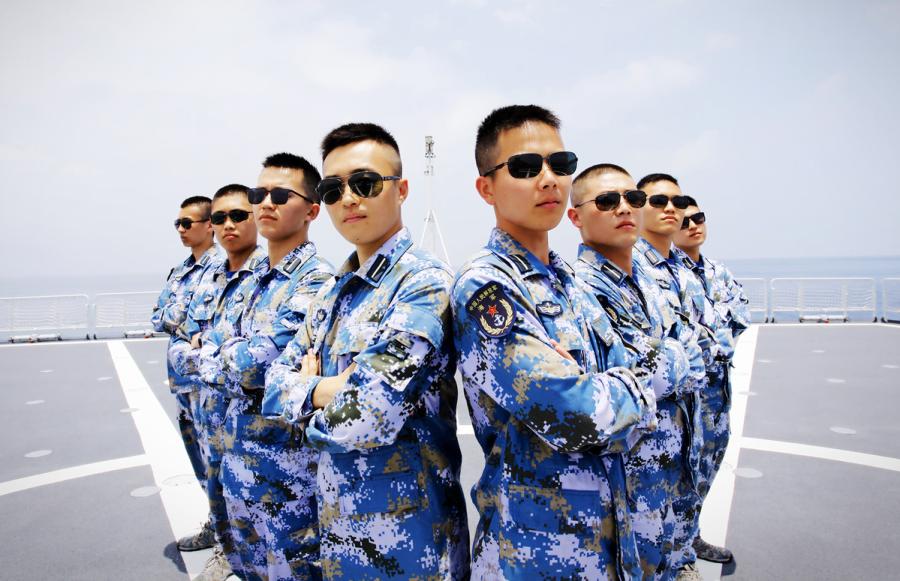 Students from Dalian Naval Academy take a graduation photo on the deck of a training vessel during their graduation practice in June 2018. (Photo provided to chinadaily.com.cn)