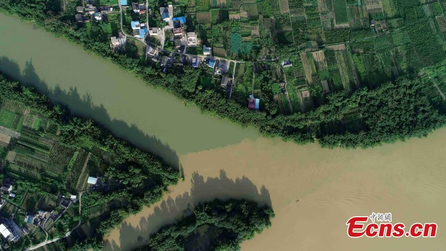An aerial view of muddy water mixing with clean after strong rainfall in Rong’an County, South China’s Guangxi Zhuang Autonomous Region, July 10, 2018. (Photo: China News Service/Tan Kaixing)