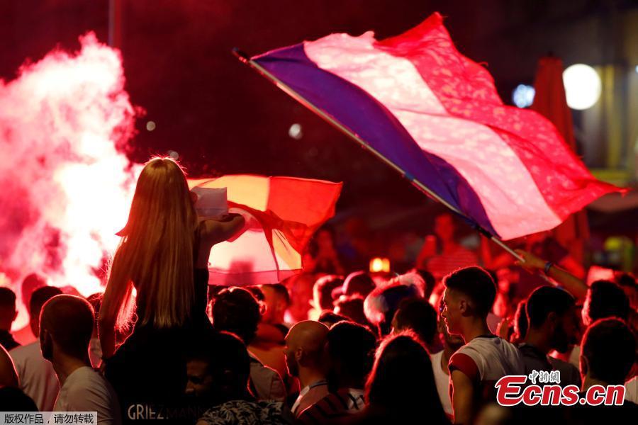 France fans react on the Champs-Elysees in Paris, France, July 10, after defeating Belgium 1-0 in their World Cup semi-final match in St Petersburg. It means the 1998 World Cup winners will play either England or Croatia in the final on Sunday. (Photo/Agencies)