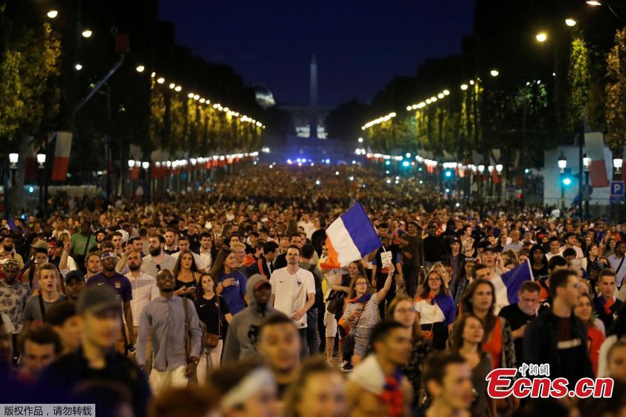 France fans react on the Champs-Elysees in Paris, France, July 10, after defeating Belgium 1-0 in their World Cup semi-final match in St Petersburg. It means the 1998 World Cup winners will play either England or Croatia in the final on Sunday. (Photo/Agencies)