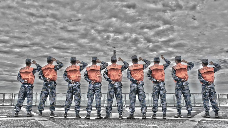 Students from Dalian Naval Academy take a graduation photo on the deck of a training vessel during their graduation practice in June 2018. (Photo provided to chinadaily.com.cn)