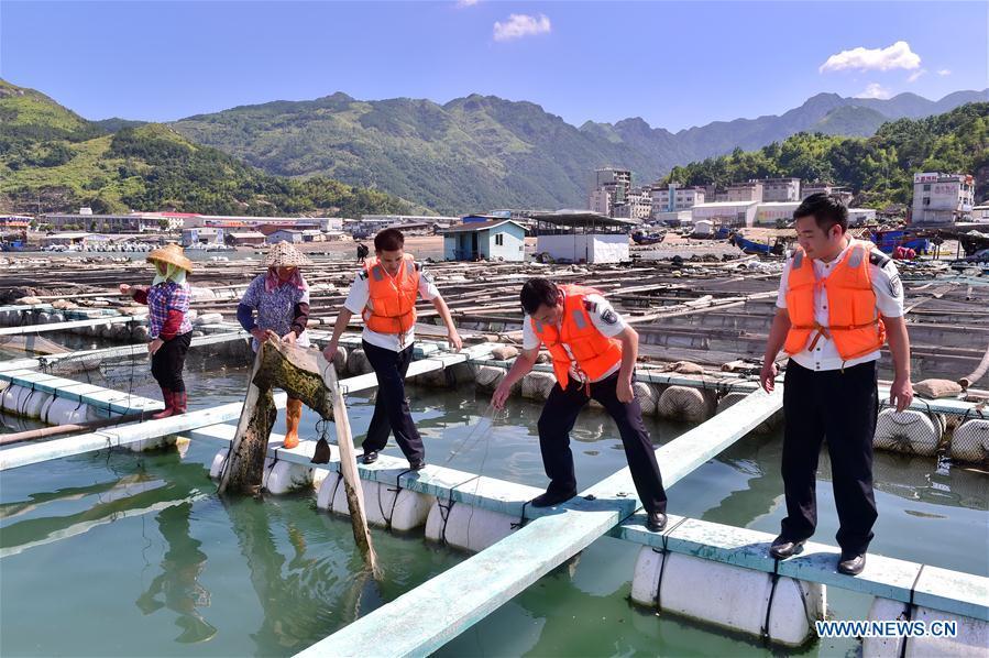 Staff members help villagers on precaution work in Cheng\'ao Village of Sanduao Town in Ningde City, southeast China\'s Fujian Province, July 10, 2018, as Typhoon Maria, the eighth typhoon this year, approaches the Chinese coast. China\'s National Meteorological Center (NMC) issued this year\'s first red alert for Typhoon Maria, which is expected to hit China\'s coastal provinces on Wednesday morning. (Xinhua/Lin Shanchuan)