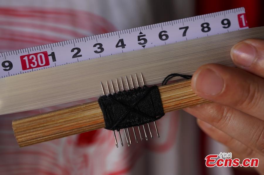 Yang Dujuan shows the tools she uses to make QR codes from bamboo strips in Sansui County, Southwest China’s Guizhou Province, July 11, 2018. A former migrant worker, Yang began to lead other villagers to make bamboo creations in 2014, trained more than 300 locals, and has now reached annual sales surpassing one million yuan ($150,000). In 2018, she began offering bamboo strips made into QR codes for clients, a creative combination of traditional bamboo weaving and the emerging popularity of codes that smartphone users can scan to access rich information. Her creation priced at 200 yuan for products was popular online. (Photo: China News Service/He Junyi)