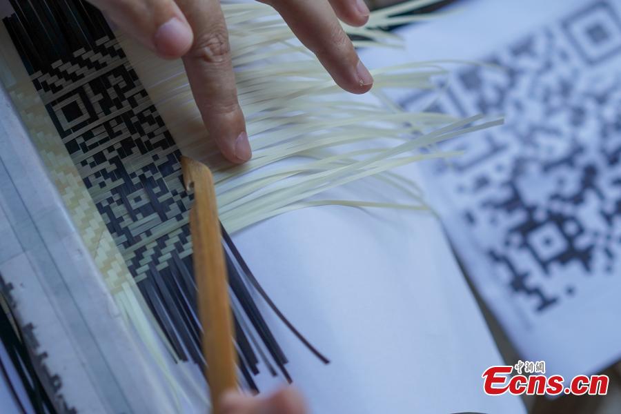 Yang Dujuan weaves a QR code using bamboo strips in Sansui County, Southwest China’s Guizhou Province, July 11, 2018. A former migrant worker, Yang began to lead other villagers to make bamboo creations in 2014, trained more than 300 locals, and has now reached annual sales surpassing one million yuan ($150,000). In 2018, she began offering bamboo strips made into QR codes for clients, a creative combination of traditional bamboo weaving and the emerging popularity of codes that smartphone users can scan to access rich information. Her creation priced at 200 yuan for products was popular online. (Photo: China News Service/He Junyi)