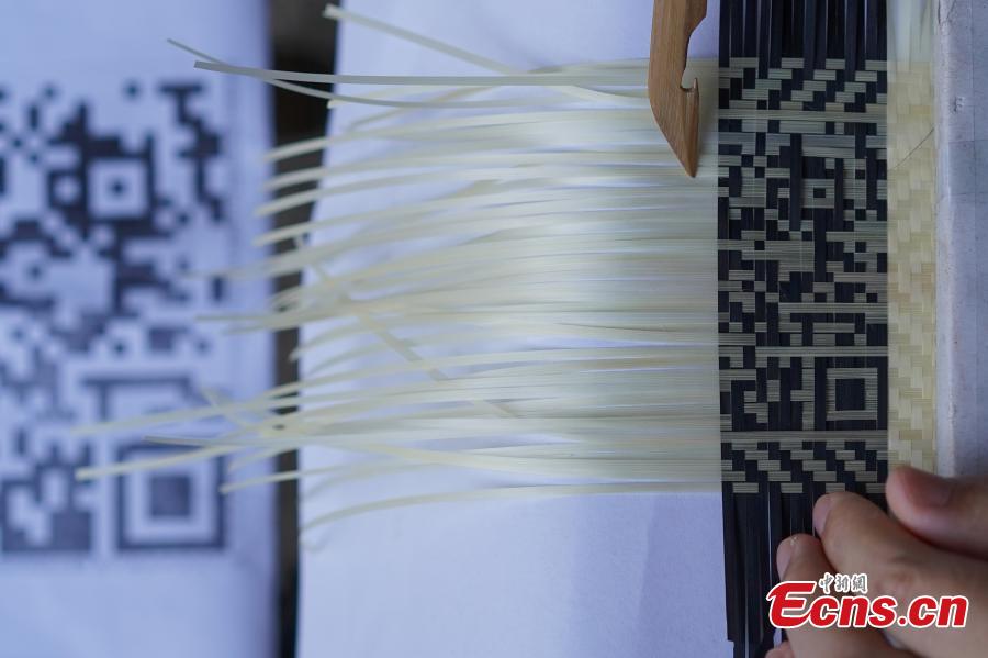 Yang Dujuan weaves a QR code using bamboo strips in Sansui County, Southwest China’s Guizhou Province, July 11, 2018. A former migrant worker, Yang began to lead other villagers to make bamboo creations in 2014, trained more than 300 locals, and has now reached annual sales surpassing one million yuan ($150,000). In 2018, she began offering bamboo strips made into QR codes for clients, a creative combination of traditional bamboo weaving and the emerging popularity of codes that smartphone users can scan to access rich information. Her creation priced at 200 yuan for products was popular online. (Photo: China News Service/He Junyi)