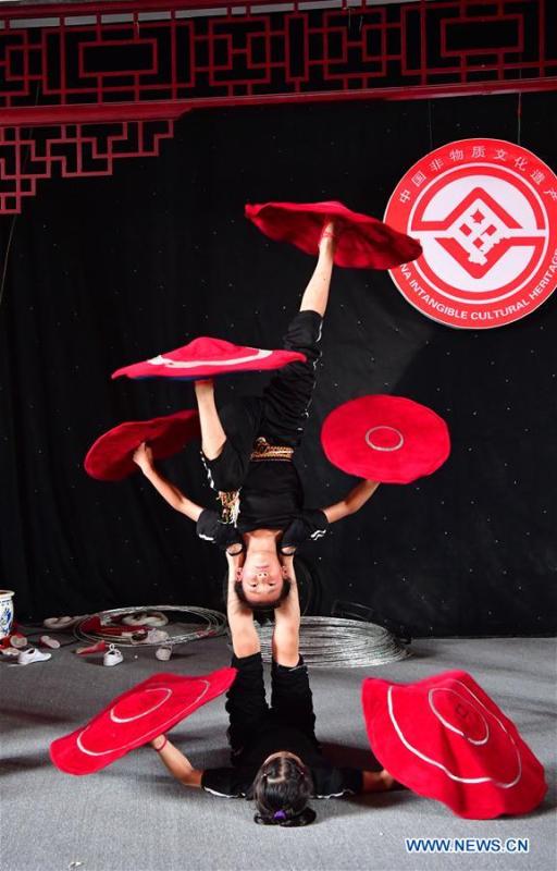 Trainees practice at an acrobatics school in Dongbeizhuang Village of Puyang, central China\'s Henan Province, July 11, 2018. In Dongbeizhuang Village, an acrobatics school enrols some 40 trainees aged between five and 15 who are faced with financial difficulties. The school offers both skills trainings and academic lessons but charges no tuition fees, preparing the trainees to join larger troupes with greater opportunities. (Xinhua/Feng Dapeng)