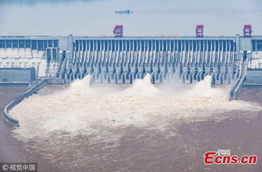 Water gushes out of the Three Gorges Dam in Yichang City, Central China’s Hubei Province. On July 14, the Three Gorges Reservoir will receive a massive 60, 000 cubic meters of water a second due to heavy rain in the upper reaches of the Yangtze River. Authorities have issued a flood alert in several provinces along the river. (Photo/VCG)