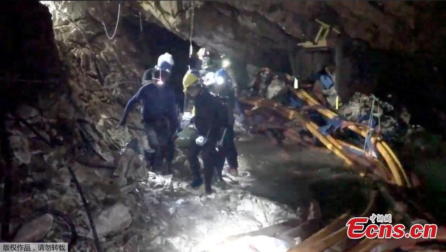 This undated image from video released via the Thai NavySEAL Facebook Page on July 11, 2018, shows rescuers hold an evacuated boy inside the Tham Luang Nang Non cave in Mae Sai, Chiang Rai province, in northern Thailand. A daring rescue mission in the treacherous confines of a flooded cave in northern Thailand has saved all 12 boys and their soccer coach who were trapped deep within the labyrinth, ending a grueling 18-day ordeal that claimed the life of an experienced volunteer diver and riveted people around the world. (Photo/Agencies)