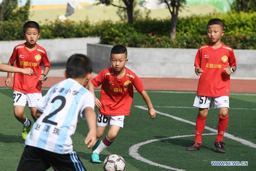 Students of a local primary school compete in a friendly soccer match during summer vacation in Renhuai, southwest China\'s Guizhou Province, July 12, 2018. (Xinhua/Chen Yong)