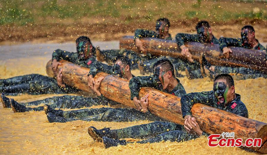 Armed police officers receive intensive training as temperatures hit 35 degrees centigrade in Xuancheng City, East China’s Anhui Province, July 12, 2018. The one-week training included skills in search and rescue in a mountain setting, shooting, and swimming across a river in combat gear. (Photo: China News Service/Ye Jingwen)