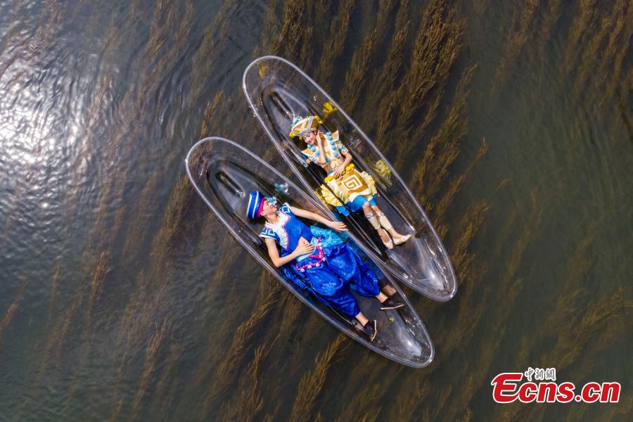 Performers lie on transparent boats as they rehearse for a show on the Lijiang River in Guilin City, South China’s Guangxi Zhuang Autonomous Region, July 15, 2018. (Photo: China News Service/Chen Chao)