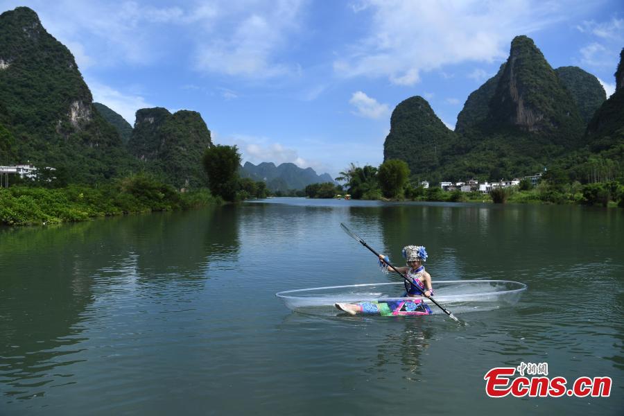 A performer rows a transparent boat in a rehearsal for a show on the Lijiang River in Guilin City, South China’s Guangxi Zhuang Autonomous Region, July 15, 2018. (Photo: China News Service/Chen Chao)