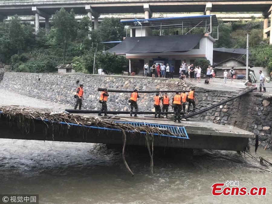 Rescuers help people affected by heavy rain and floods in Lueyang County, Northwest China’s Shaanxi Province. Six hours of heavy rain on July 13 and 14 caused landslides in the county, cutting off power and telecommunication and transportation links in many areas, and causing a direct economic loss of 193 million yuan ($28.8 million). Hundreds of firefighters and police officers, including armed police, have joined search and rescue efforts. Some police officers had to walk on foot for 57 kilometers. (Photo/VCG)