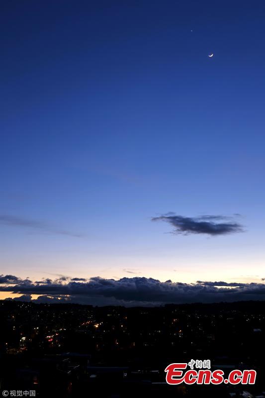 Venus (above) appears in the night sky near a crescent moon on July 15, 2018 in Bogota, Colombia. The conjunction of the planet Venus was seen next to the crescent moon and the regulus star from sunset to sunrise. (Photo/VCG)