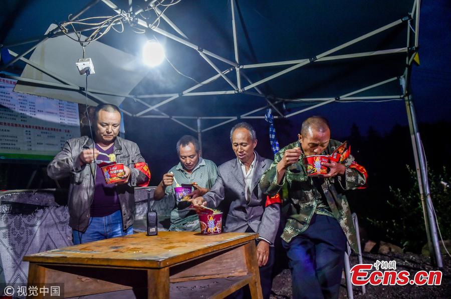 Mou Huaiqing, 65, and his colleagues eat instant noodles for dinner as they patrol a valley in Dujiangyan City, Southwest China’s Sichuan Province. For the past nine years, since the deadly May 12 earthquake in 2008, Mou and his colleagues have been responsible for 24-hour monitoring of the valley from May to October for signs of potential landslides that could pose a threat to local villagers. They check for any cracks on mountain slopes, for example. Mou helped evacuate 300 residents and tourists in a timely manner as he sounded an alarm to warn of a landslide in August 2010. The team has sounded warnings for a dozen geological hazards. (Photo/VCG)
