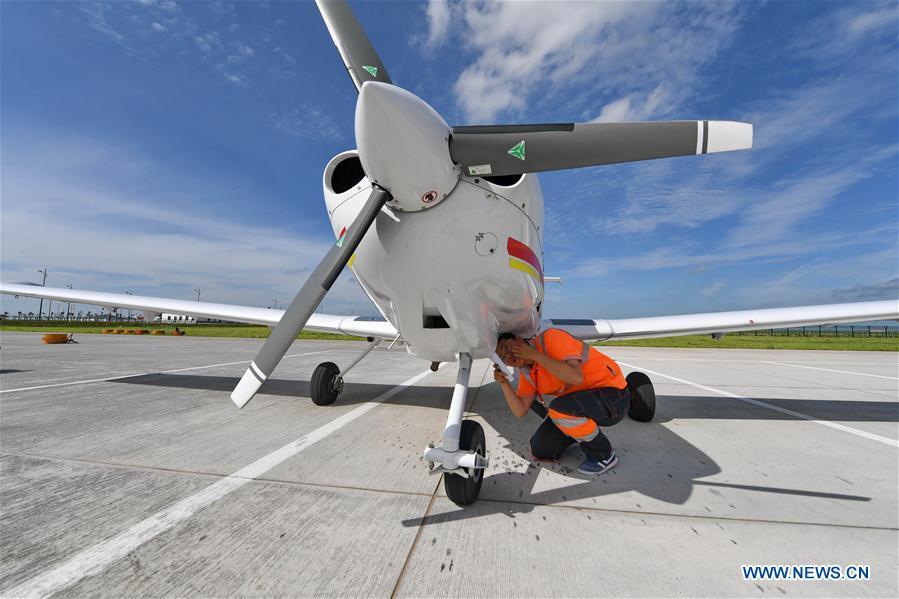 Deng Yun checks an aircraft at the Chagan Lake airport in Songyuan, northeast China\'s Jilin Province, July 17, 2018. Deng was born in 1991. She is an aircraft maintenance technician of an aviation academy in Jilin. The young female engineer and other nine colleagues are in charge of training plane maintenance at the airport. To ensure the flight safety, they need to check more than 100 items before a plane takes off. (Xinhua/Zhang Nan)