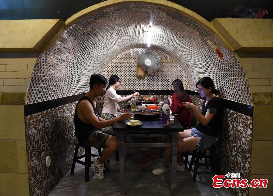 A popular hot pot restaurant inside a former air-raid shelter in Southwest China’s Chongqing Municipality, July 17, 2018. Authorities in Chongqing have allowed for the development of air-raid shelters, and they have been converted into wine cellars, restaurants and gas stations. The venues become especially popular in summer as it’s usually cool inside. (Photo: China News Service/Zhou Yi)