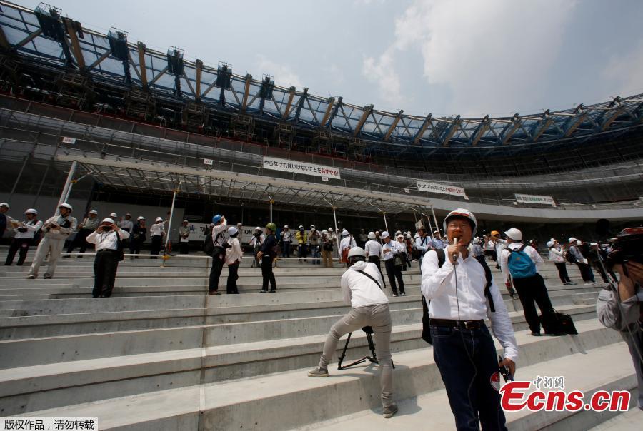 Workers and media members are seen at the construction site of the New National Stadium, the main stadium of Tokyo 2020 Olympics and Paralympics, during a media opportunity in Tokyo, Japan, July 18, 2018. As the two-year mark approaches for the Tokyo 2020 Olympics, Japan is being scorched by an intense heatwave that has prompted fears of similar extreme weather when the sporting showpiece takes place in the country. (Photo/Agencies)