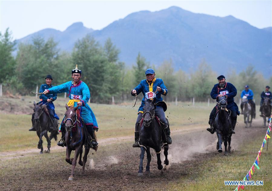 Herdsmen compete in a horse race during a Nadam fair in Chifeng City, north China\'s Inner Mongolia Autonomous Region, July 20, 2018. Nadam Fair, meaning \