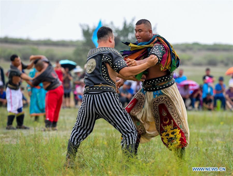 Two wrestlers compete during a Nadam fair in Chifeng City, north China\'s Inner Mongolia Autonomous Region, July 20, 2018. Nadam Fair, meaning \