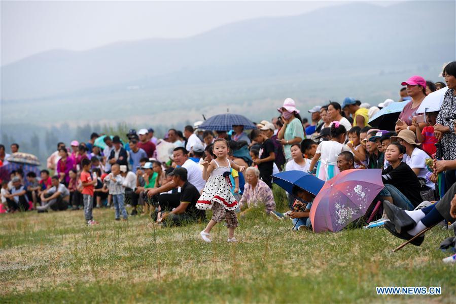 Tourists watch the sports events during a Nadam fair in Chifeng City, north China\'s Inner Mongolia Autonomous Region, July 20, 2018. Nadam Fair, meaning \
