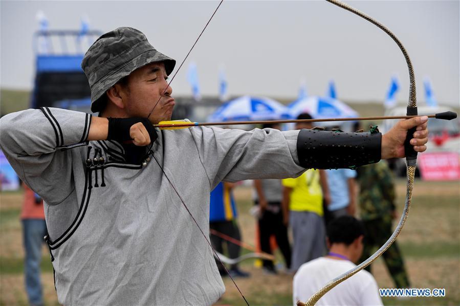 A competitor takes part in an archery contest during a Nadam fair in Chifeng City, north China\'s Inner Mongolia Autonomous Region, July 20, 2018. Nadam Fair, meaning \