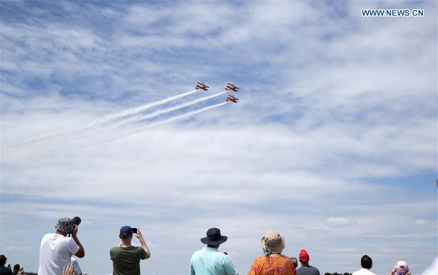 People watch a flying display at the Farnborough International Airshow, south west of London, Britain on July 22, 2018. (Xinhua/Han Yan)