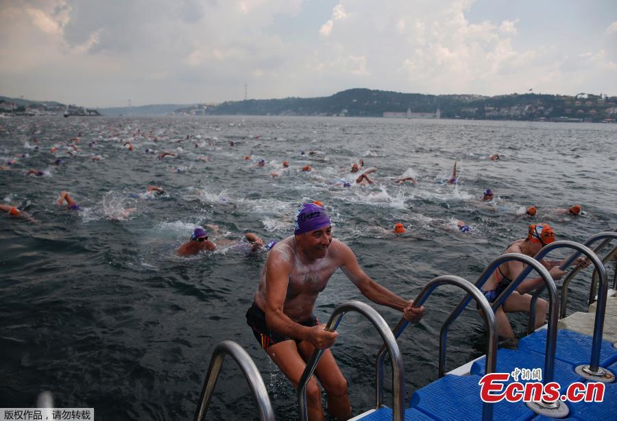 An athlete gets out of the water after he swam from Asia to Europe in the Bosphorus strait during the Bosporus Cross-Continental Swimming Race in Istanbul, July 22, 2018. Over 2,000 open-water competitors plunged into the water from a ferry docked on the city\'s Asian side and swam for about 6.5km in the cross-continental event. (Photo/Agencies)