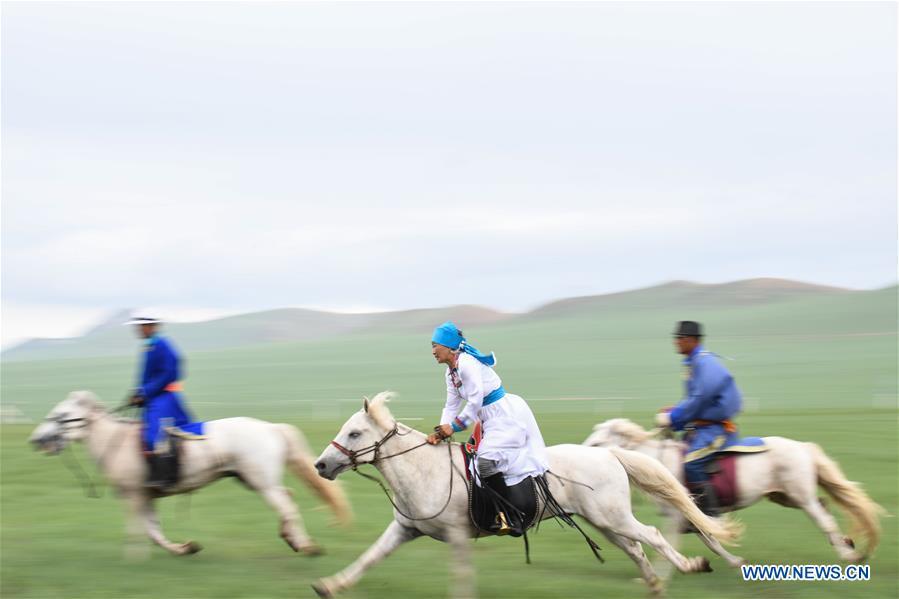 Herdsmen ride horses during a competition celebrating Baima Festival held in West Ujimqin Banner, north China\'s Inner Mongolia Autonomous Region, July 21, 2018. The two-day event is a mass traditional Mongolian festival mainly filled with sports events. (Xinhua/Liu Lei)