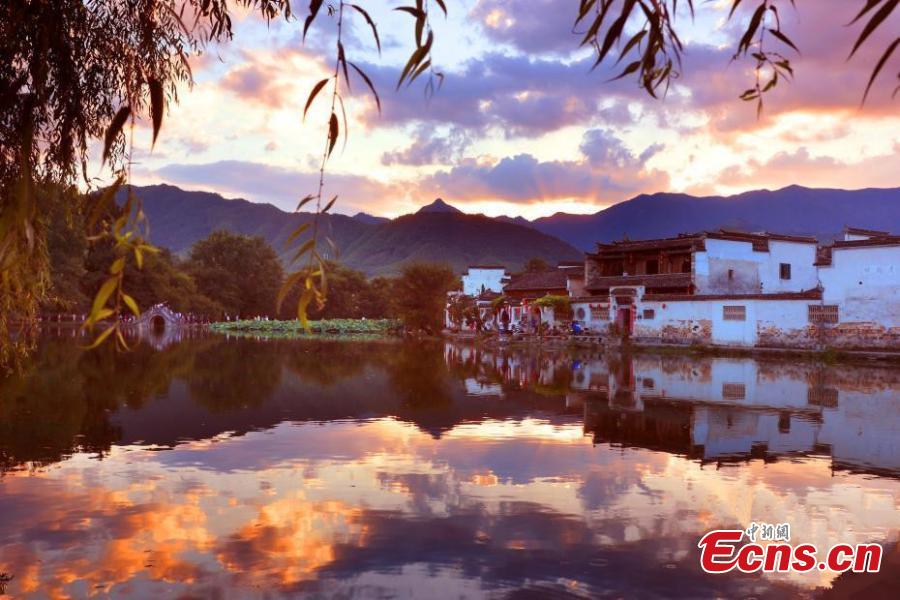 A spectacular view of Nanhu Lake in Hongcun Village at sunset in Huangshan City, Anhui Province. The two traditional villages of Xidi and Hongcun were inscribed as UNESCO World Heritage sites in 2000 as their unique landscapes, architectural forms, decorative features, and construction techniques all retain the original features of Anhui villages from the 14th to 20th centuries. (Photo: China News Service/Shi Guangde)