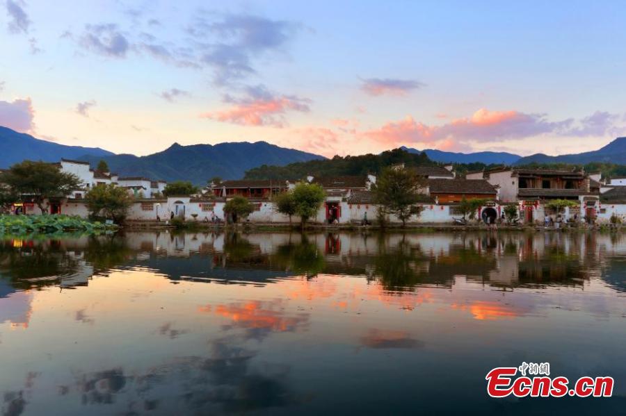 A spectacular view of Nanhu Lake in Hongcun Village at sunset in Huangshan City, Anhui Province. The two traditional villages of Xidi and Hongcun were inscribed as UNESCO World Heritage sites in 2000 as their unique landscapes, architectural forms, decorative features, and construction techniques all retain the original features of Anhui villages from the 14th to 20th centuries. (Photo: China News Service/Shi Guangde)