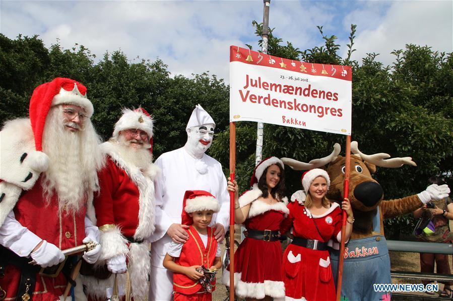 People dressed as Santa Claus pose for photos in Copenhagen, capital of Denmark, on July 23, 2018. The 2018 World Santa Claus Congress kicked off at Bakken amusement park, north of Copenhagen, on Monday. Some 100 Santa Claus from around the globe gathered here in the Danish capital city during the four-day event. (Xinhua/Wu Bo)