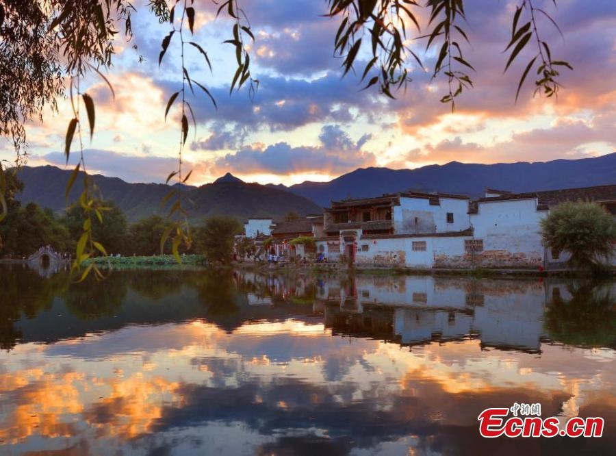 A spectacular view of Nanhu Lake in Hongcun Village at sunset in Huangshan City, Anhui Province. The two traditional villages of Xidi and Hongcun were inscribed as UNESCO World Heritage sites in 2000 as their unique landscapes, architectural forms, decorative features, and construction techniques all retain the original features of Anhui villages from the 14th to 20th centuries. (Photo: China News Service/Shi Guangde)