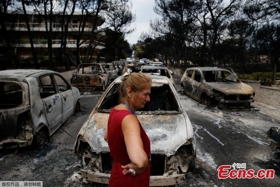 A local stands next to burnt cars following a wildfire at the village of Mati, near Athens, Greece, July 24, 2018. Greece’s prime minister told of the “unspeakable tragedy” the country faced after at least 74 people were killed by wildfires that swept through a resort, trapping people in cars and on the edge of cliffs as others were forced to jump off to survive. (Photo/Agencies)