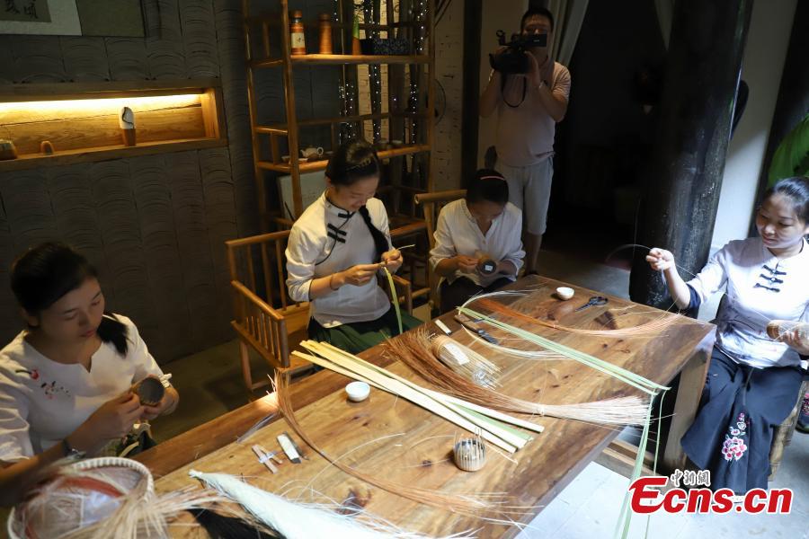Yang Changqin, a master of bamboo weaving, works in a studio in Datong Ancient Town in Chishui City, Southwest China’s Guizhou Province, July 24, 2018. The town has made efforts to creatively develop traditional handicrafts including bamboo weaving and oil-paper umbrella, which help lift locals out of poverty. Yang leads more than 20 local people in a bamboo weaving business, achieving an annual revenue of three million yuan. (Photo: China News Service/Qu Honglun)