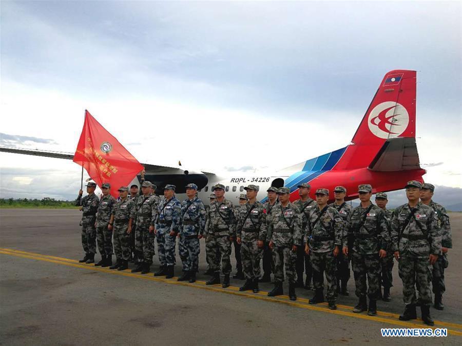 A Chinese People\'s Liberation Army (PLA) medical team arrive at the airport in Attapeu, Laos, July 25, 2018. A medical contingent from the Chinese People\'s Liberation Army (PLA), which is on the \