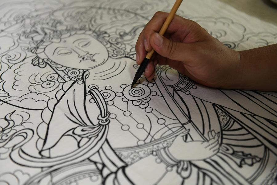 Yao Shulong makes replicas of traditional Chinese New Year paintings of Pilu Temple in his studio on July 24, 2018. (Photo/Xinhua)
