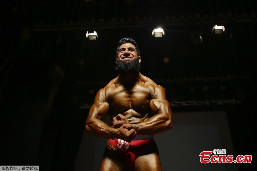 A Kashmiri bodybuilder displays his muscles at a bodybuilding competition in Srinagar, Indian controlled Kashmir, July 28, 2018. Dozens participated in the competition to choose Mr. Kashmir on Saturday. (Photo/Agencies)