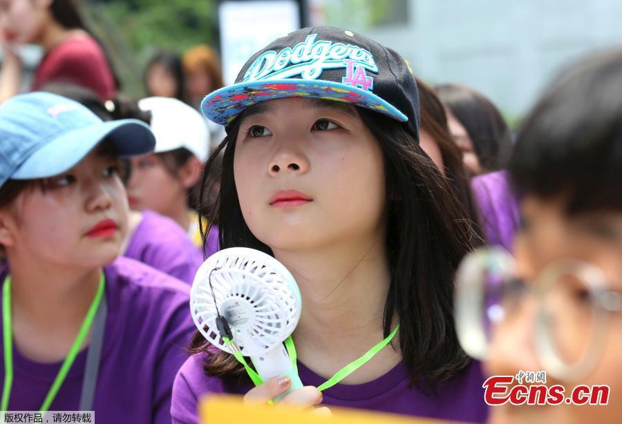 Middle school students use portable fans amid the sweltering heat during a rally demanding full compensation and apology for wartime sex slaves from Japanese government in front of the Japanese embassy in Seoul, South Korea, Aug. 1, 2018. South Korean Meteorological Administration issued a heat wave warning for Seoul and other cities. (Photo/Agencies)