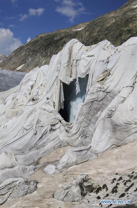 Photo taken on Aug. 5, 2018 shows the Rhone Glacier covered with white blankets near the Furka Pass in Switzerland. The Rhone Glacier is protected by special white blankets to prevent it from further melting as a result of global warming. (Xinhua/Xu Jinquan)