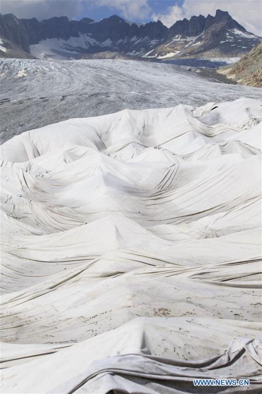 Photo taken on Aug. 5, 2018 shows the Rhone Glacier covered with white blankets near the Furka Pass in Switzerland. The Rhone Glacier is protected by special white blankets to prevent it from further melting as a result of global warming. (Xinhua/Xu Jinquan)