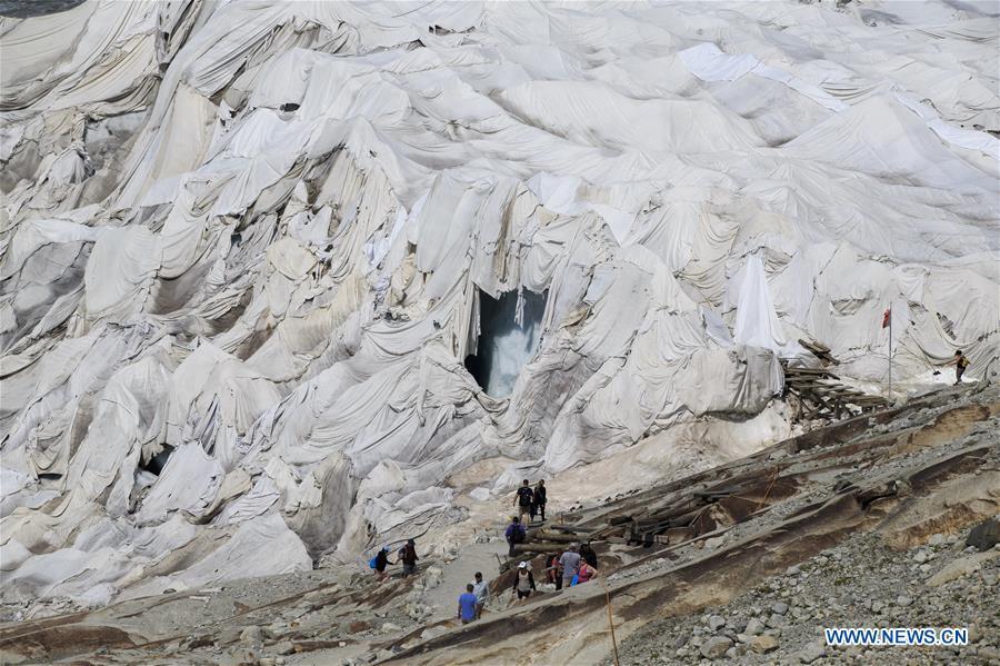 Photo taken on Aug. 5, 2018 shows the Rhone Glacier covered with white blankets near the Furka Pass in Switzerland. The Rhone Glacier is protected by special white blankets to prevent it from further melting as a result of global warming. (Xinhua/Xu Jinquan)