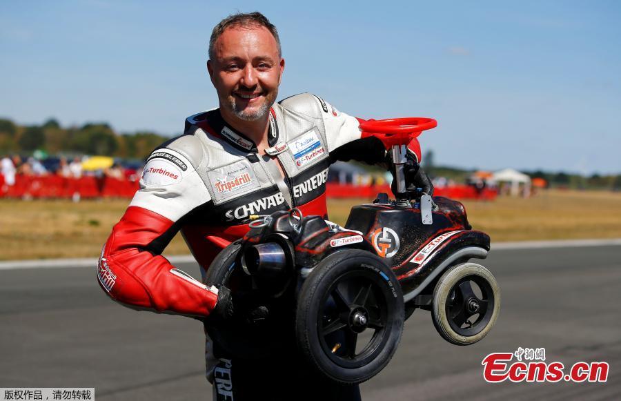 German extreme athlete Dirk Auer poses with his jet-powered Bobby car after setting a new world record at 119.68 km/h during an airport racing event in Bottrop-Kirchhellen, western Germany, Aug. 5, 2018. (Photo/Agencies)